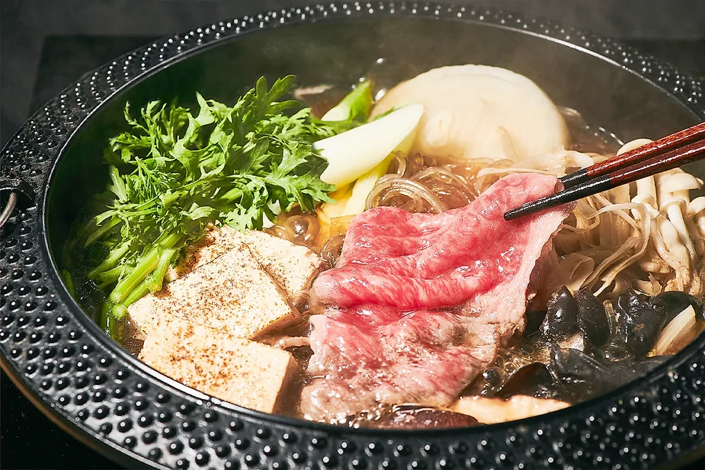 Shabu-shabu pot with thinly sliced meat, vegetables, and mushrooms at Modern Shabu House