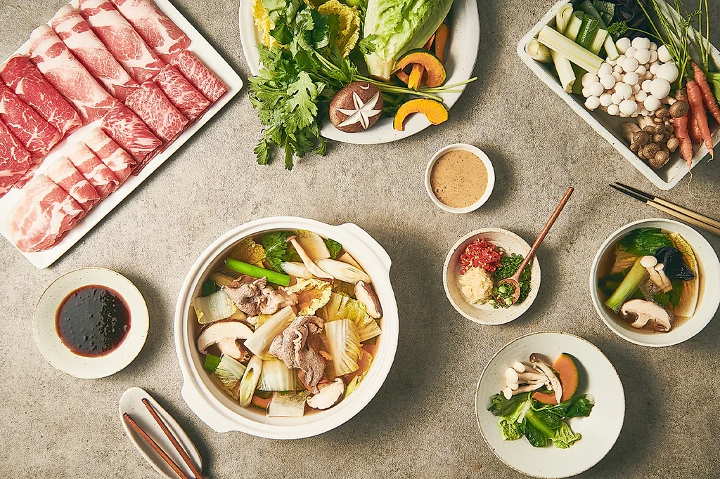 Shabu-shabu table setting with meat and vegetables at Modern Shabu House