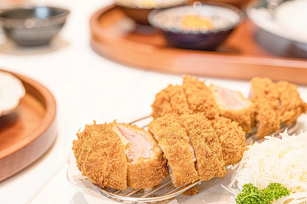 A plate at Donkachun with thick-cut tonkatsu and shredded cabbage