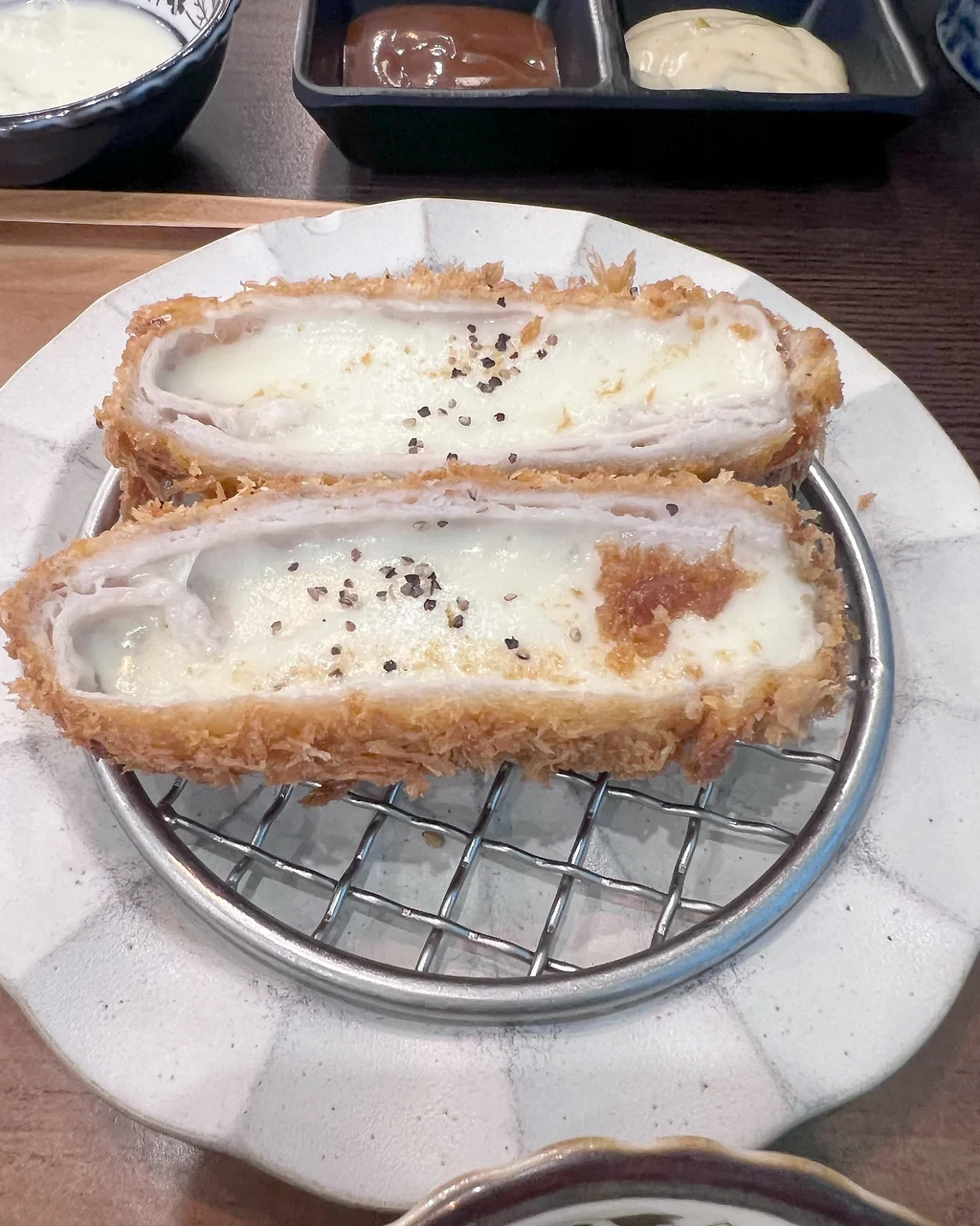 Cross-section of Donkachun cheese tonkatsu filled with cheese