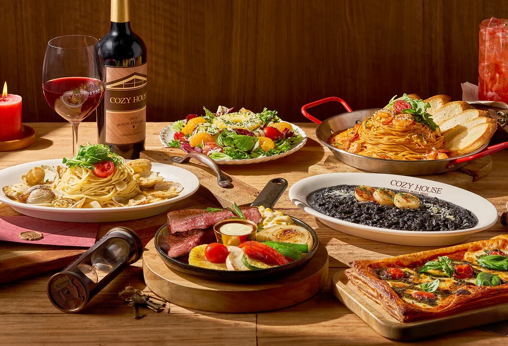 A table set with various dishes including steak and pasta at Cozy House